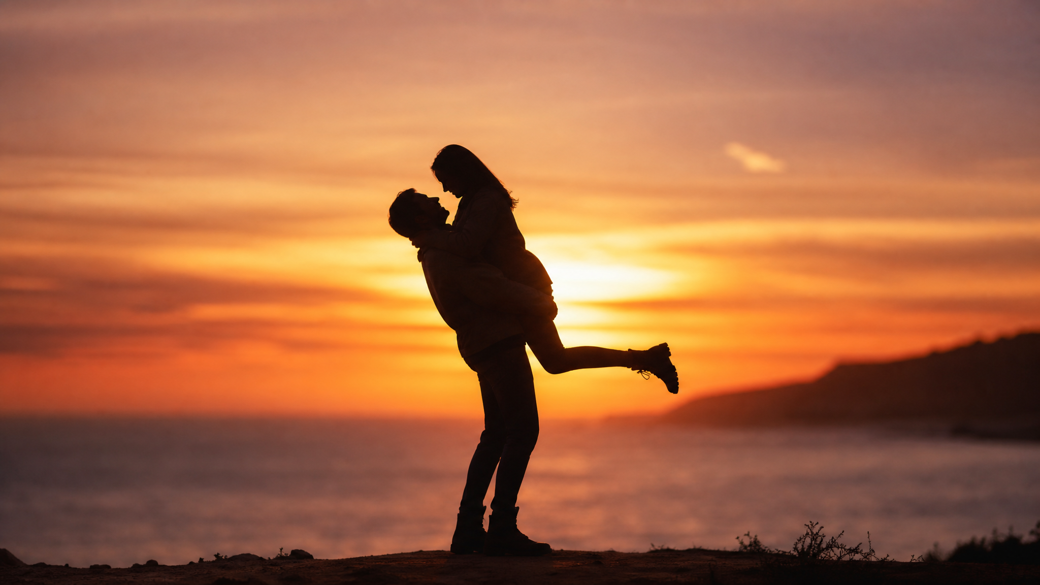 Adventurous couple taking a playful, tasteful outdoor photo together